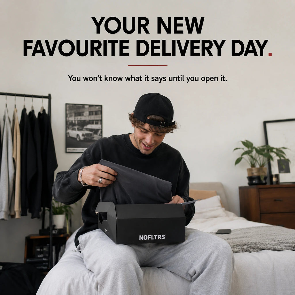 A man sitting on a bed in a bedroom opens a black NOFLTRS shoe box, revealing a dark gray shoe inside. Large promotional text at the top reads 'YOUR NEW FAVOURITE DELIVERY DAY.