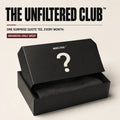 A black mystery box with its lid open, showing a folded dark garment inside. Large text at the top reads 'THE UNFILTERED CLUB' with smaller copy below and a badge that says 'MEMBERS-ONLY DROP.